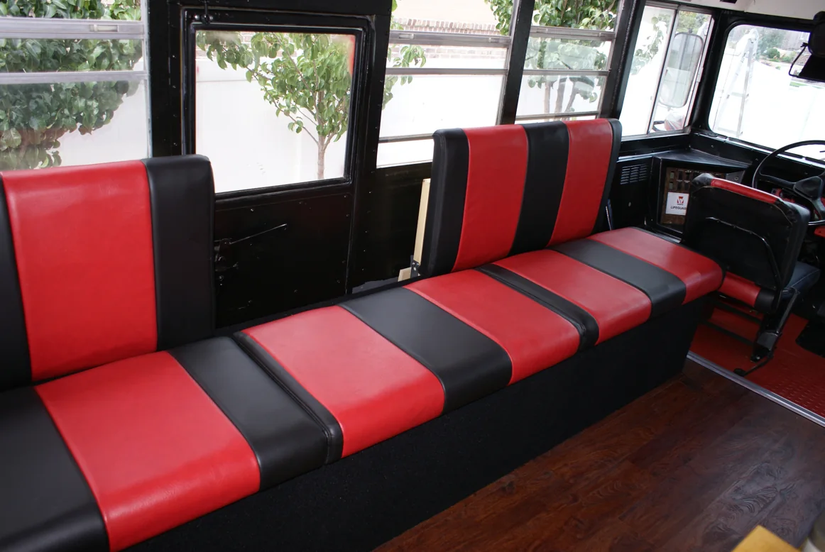 A long striped bench running toward the front of the bus