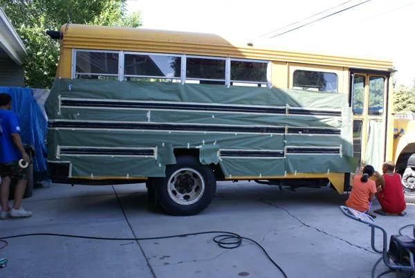 The bus wrapped in plastic and tape, ready for the paint booth