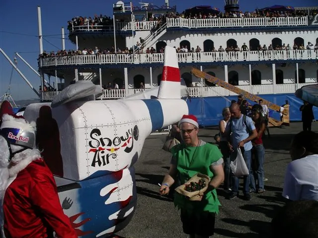 The crew’s white Snow Air flying machine with elves at the San Francisco pier