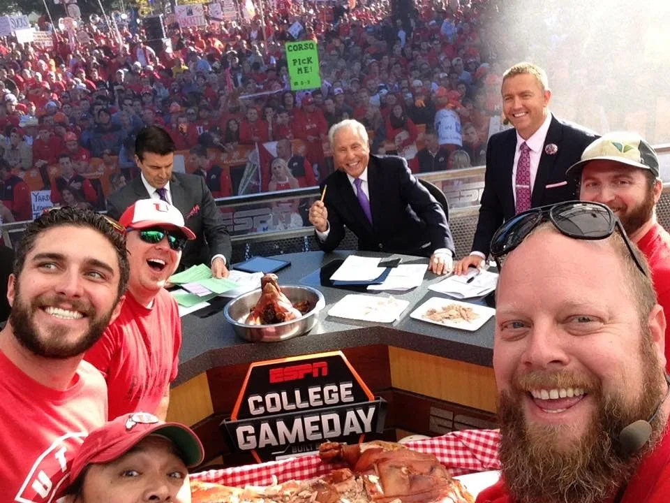 Pig Bus crew members taking a selfie with the hosts at the ESPN College GameDay desk
