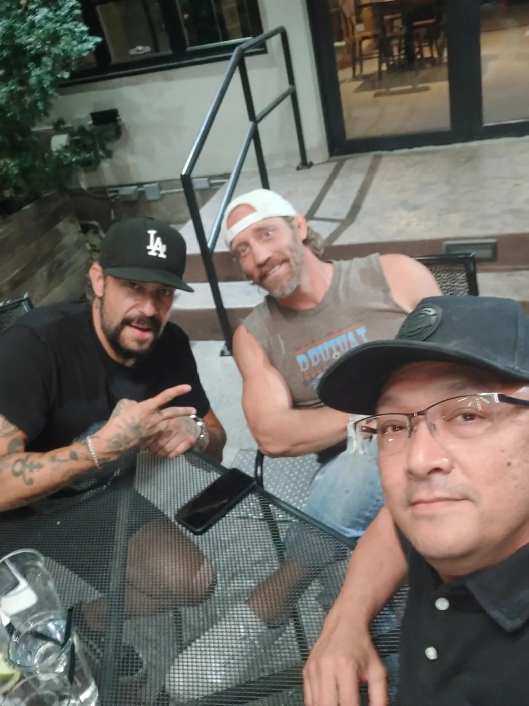 Three friends grabbing dinner on a patio