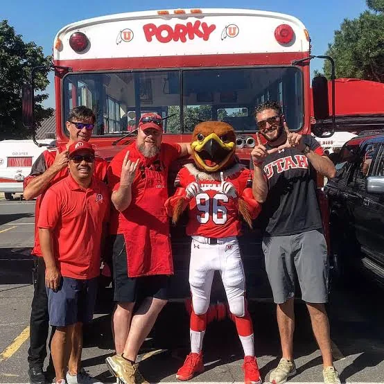 Crew members posing with the Utah Swoop mascot in front of Porky