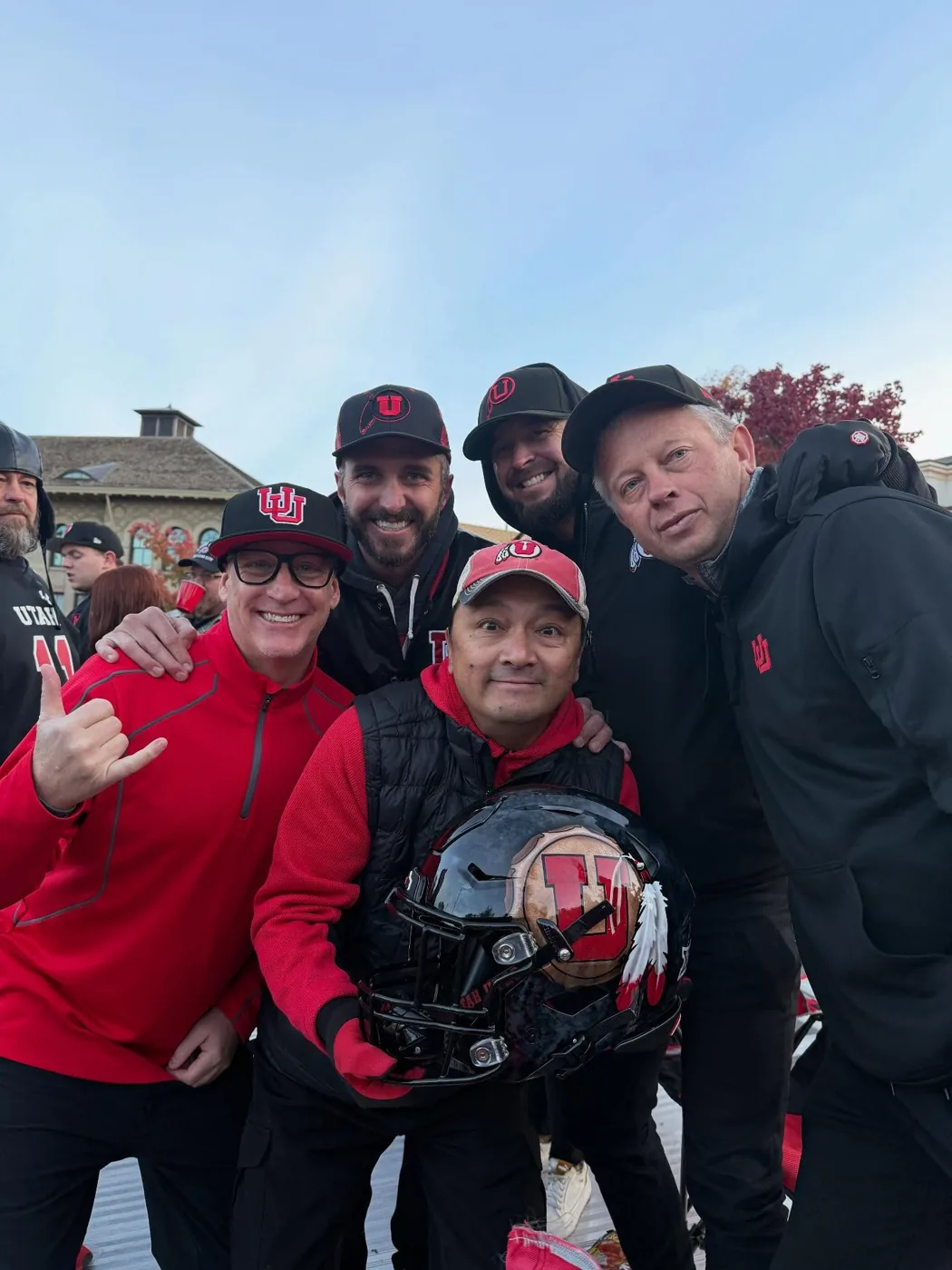 Crew members on the roof deck with a Utah football helmet