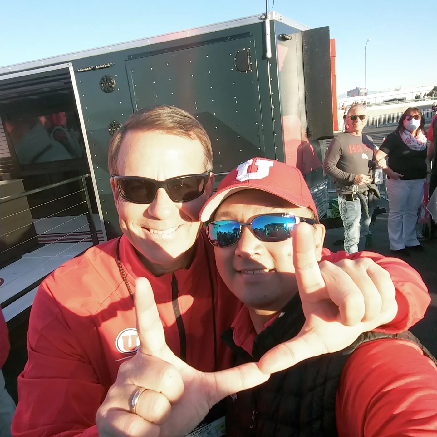 A crew member and a Utah fan throwing the U together in Las Vegas